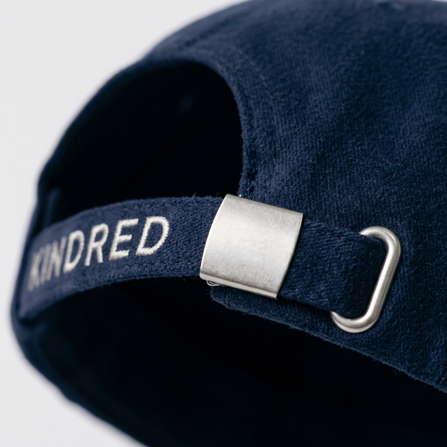 Close-up of the metal clasp closure and KINDRED strap