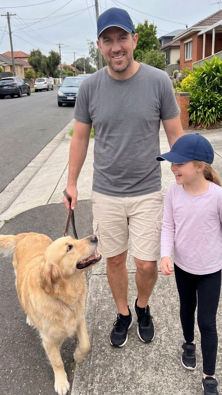 Navy — father and daughter in matching navy Kindred Caps walking the dog